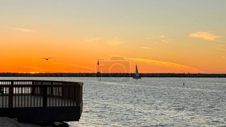 Photo for Bright orange sunset over the pacific ocean in Marina del Rey, CA in winter - Royalty Free Image