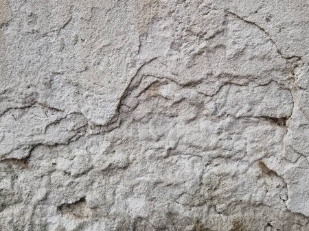 Photo for A closeup of a gray cracked wall. - Royalty Free Image