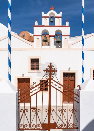 Foto de Un primer plano vertical de un antiguo edificio de la Iglesia en Santorini, Grecia, en un día soleado - Imagen libre de derechos