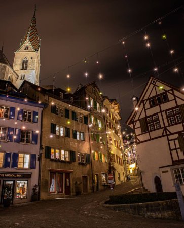 An outdoor view of a historic old town with Christmas lights in Baden, Switzerland