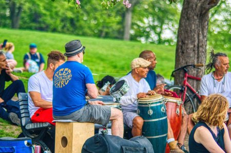 Photo for People enjoying early summer weather at a drum circle at Monument a sir George-Etienne Cartier, Montreal, Quebec - Royalty Free Image