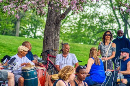 Photo for People enjoying early summer weather at a drum circle at Monument a sir George-Etienne Cartier, Montreal, Quebec - Royalty Free Image