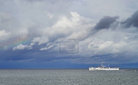 Photo for A ferry boat sailing on the Baltic Sea at Travemunde under a beautiful cloudy sky - Royalty Free Image