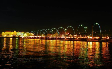 Photo for The Queen Emma bridge lit up over St Anna Bay in Willemstad on Curacaos Independence Night. - Royalty Free Image