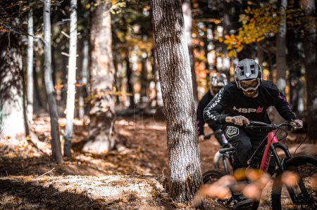 Photo for A horizontal shot of two riders shredding local trails in brand new stuff from Holeshotpunx - Royalty Free Image