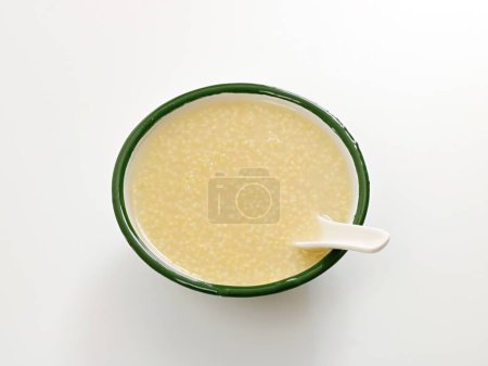 Photo for A close-up shot of millet porridge in a bowl on white background - Royalty Free Image