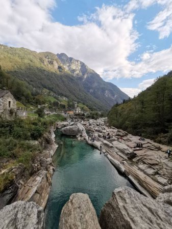 Photo for A vertical shot of a river with an imposing mountainscape at Valle Verzasca - Royalty Free Image