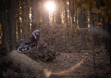 Photo for The rider shredding local trails in brand new stuff from Holeshotpunx in a horizontal action shot in the fall - Royalty Free Image