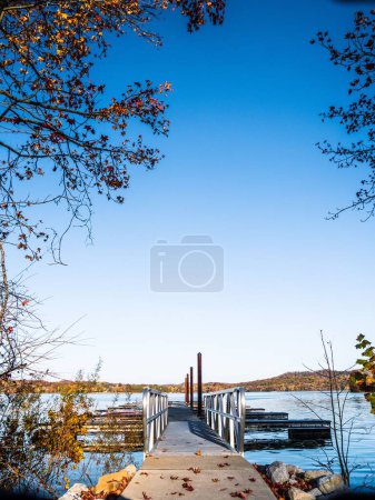 Photo for A vertical shot of a wooden pier on Ohio Lake in autumn - Royalty Free Image