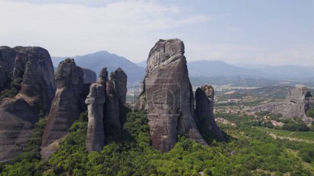 Photo for An aerial view of rock formations surrounded by dense trees in Meteora - Royalty Free Image