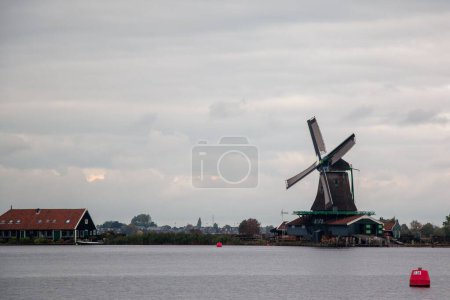 Photo for The windmills and wooden houses in the Zaanse Schans, Zaanstad, Netherlands. - Royalty Free Image