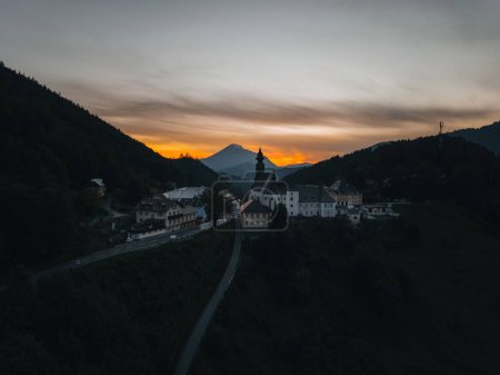 Photo for A drone shot of sunset in a small rural village in the Austrian mountains - Royalty Free Image