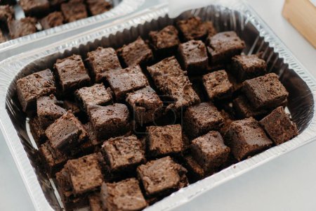 Photo for A close-up shot of brownie pieces in a disposable baking sheet - Royalty Free Image