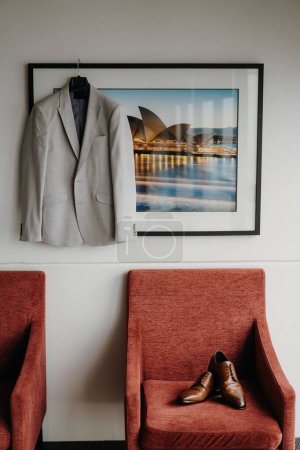 Foto de Una toma vertical del traje de negocios del hombre y zapatos elegantes en la habitación - Imagen libre de derechos