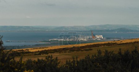 Photo for An aerial view of Hinkley Point Nucellar Power station construction surrounded by water - Royalty Free Image