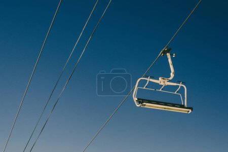 Foto de Un teleférico de pasajeros elevado en un día soleado con un cielo azul en el fondo - Imagen libre de derechos
