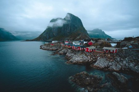 Photo for A breathaking view of a fishing village located on a rocky shore in Lofoten archipelago in Norway on a gloomy day - Royalty Free Image