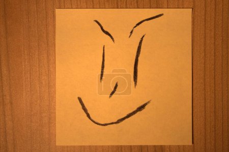 Photo for Post-it note with spiteful, gloating face expression - Royalty Free Image