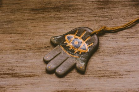 Photo for A hand of fatima on rustic wooden background - Royalty Free Image