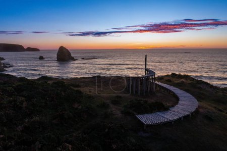 Téléchargez les photos : Un beau plan d'un sentier de randonnée en bois avec le fond de l'océan lors d'un coucher de soleil - en image libre de droit