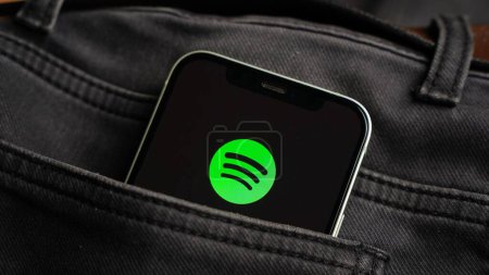 Photo for Spotify music app on the smartphone, app for music, radio and podcast streaming, ios smart phone - Royalty Free Image