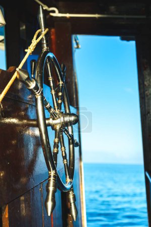 Photo for A vertical shot of a boat classic cabin from inside with a sea in the background - Royalty Free Image