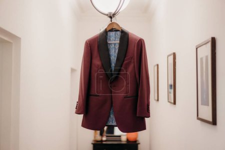 Photo for A selective of a groom's dress hanging in a room - Royalty Free Image