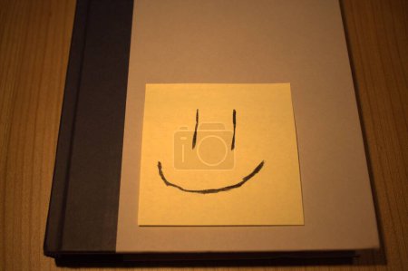 Téléchargez les photos : Joyeux sourire visage Post-it sur le livre - en image libre de droit