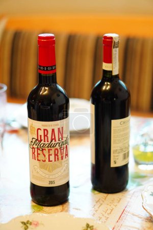 Photo for A vertical shot of Gran Reserva wine in a bottle standing on a table - Royalty Free Image