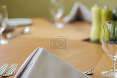 Photo for A selective focus of a white napkin on a restaurant dining table - Royalty Free Image