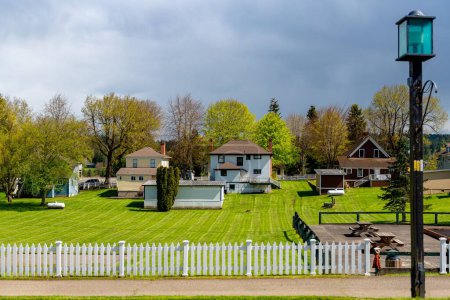 Photo for A neighborhood of typical small houses with green lawn in Port Gamble, Washington, USA - Royalty Free Image