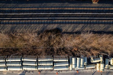 Photo for An aerial shot of train tracks with construction pipes and tubes - Royalty Free Image