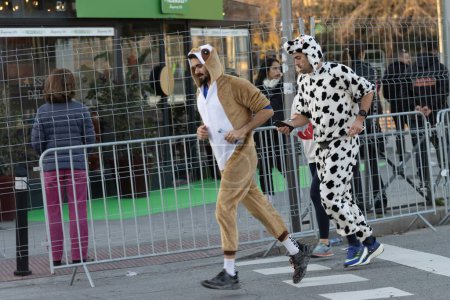 Photo for Madrid, Spain, -December,31,2022, popular race of San Silvestre through the streets of the city, where old people, young people and with a lot of colo - Royalty Free Image