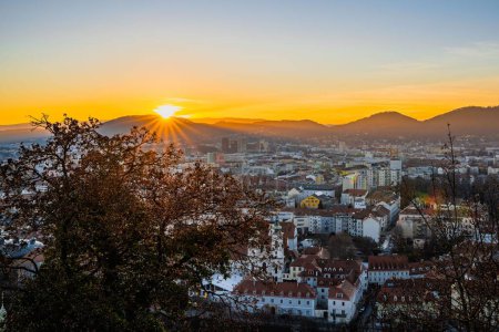 Photo for A golden sunrise over the mountain and city buildings - Royalty Free Image