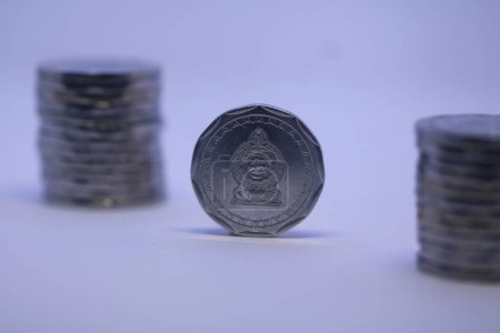Photo for A front view of a Sri Lankan 11 sided coin with background pile of coins - Royalty Free Image