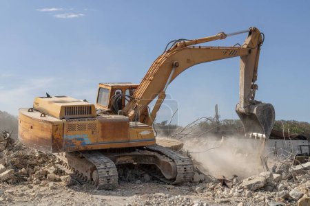 Photo for An excavator loading rubble into a dump truck - Royalty Free Image