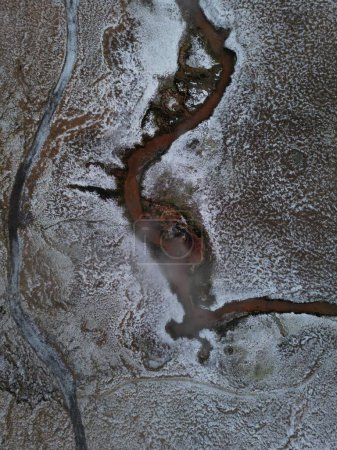 Téléchargez les photos : Vue aérienne d'une rivière dans la vallée enneigée. Reykjadalur, Islande. - en image libre de droit