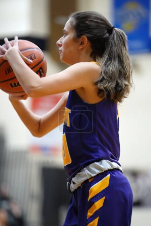 Photo for A vertical shot of a girl playing basketball during the girls fall high school tournament in Australia - Royalty Free Image