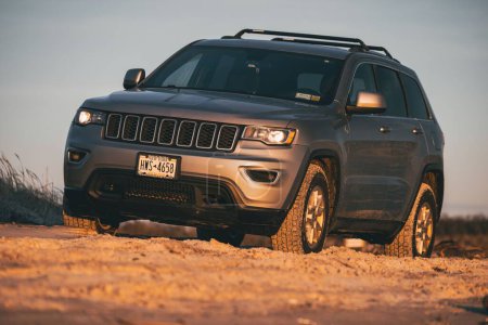 Photo for A gray 2018 Jeep Grand Cherokee at the beach at sunset - Royalty Free Image