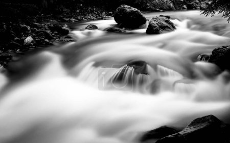Photo for A long-exposure monochrome shot of the waterfall flowing over the rocks and stones - Royalty Free Image