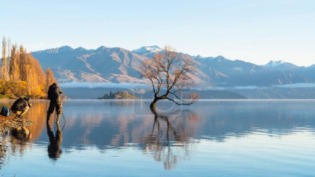 Foto de Los fotógrafos tomando una foto del espejo escénico Lago Wanaka agianst las montañas de Nueva Zelanda - Imagen libre de derechos
