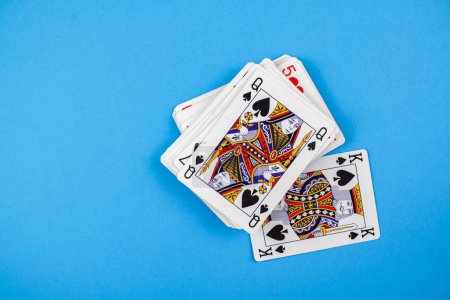 Photo for A top view of a pack of playing cards isolated on a blue background - Royalty Free Image