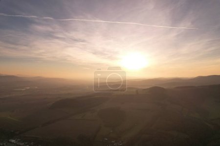 Photo for A drone view of an amazing sunset sky over green field - Royalty Free Image