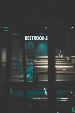 Photo for A vertical of a dark hall leading to restrooms - Royalty Free Image
