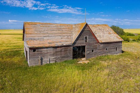 Téléchargez les photos : Vue aérienne d'une ancienne ferme en bois abandonnée avec le champ en arrière-plan à Glenside Canada - en image libre de droit