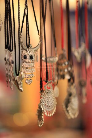 Photo for A selective closeup of necklaces hanging in a market - Royalty Free Image
