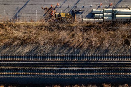 Photo for An aerial shot of train tracks with construction pipes and tubes - Royalty Free Image