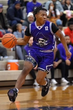 Photo for A young black basketball player in blue jersey dribbling the ball - Royalty Free Image