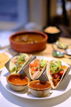 Photo for A Mexican tacos on a plate with sauce - Royalty Free Image