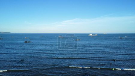 Photo for A drone view of the beautiful seascape with a ship and boats under a blue sky - Royalty Free Image